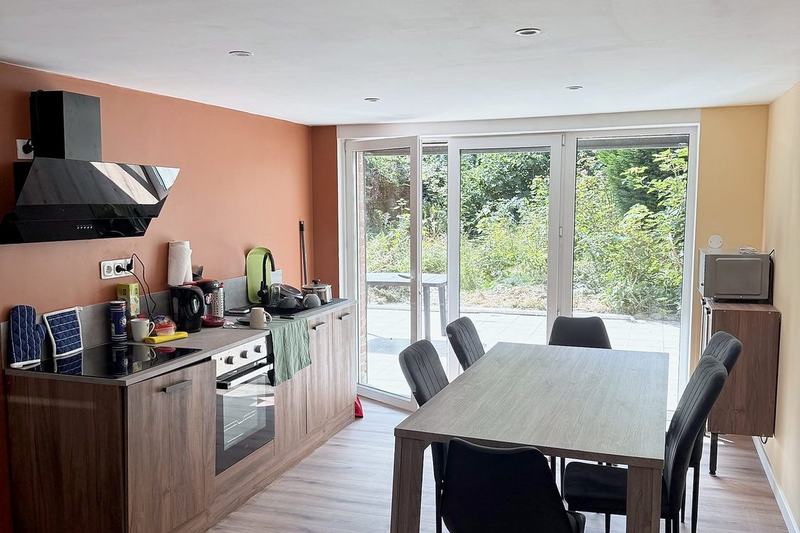 Fitted kitchen with a dining table and patio doors onto the garden
