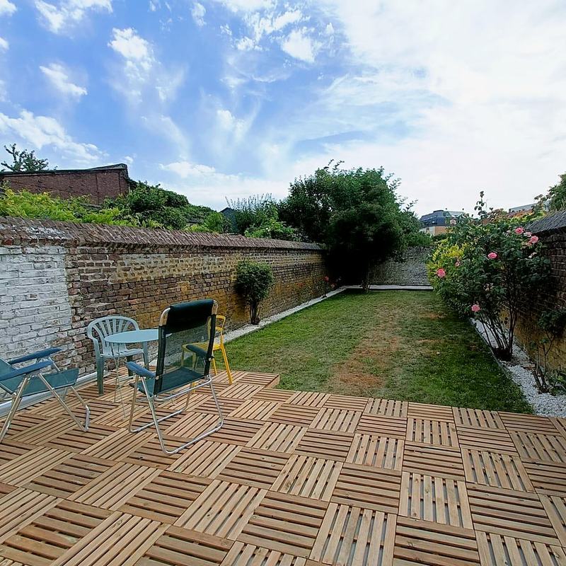 Wooden terrace and a long lawn