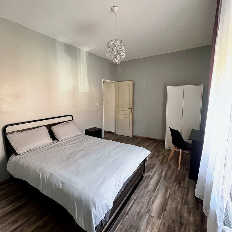 Bedroom with a double bed, wardrobe and desk