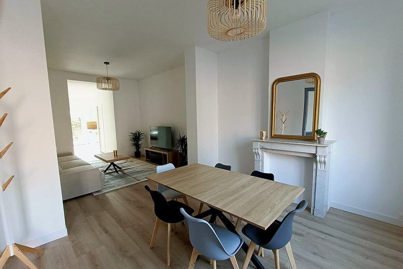 Dining area with a table for six and the living room beyond